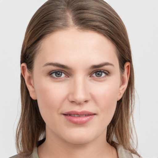 Joyful white young-adult female with medium  brown hair and grey eyes