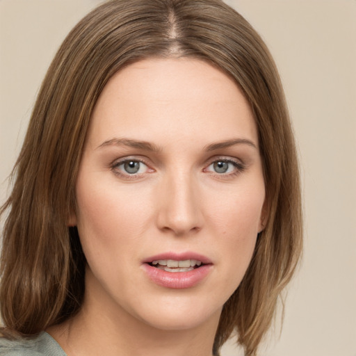 Joyful white young-adult female with medium  brown hair and green eyes