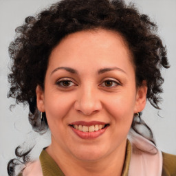 Joyful black adult female with medium  brown hair and brown eyes