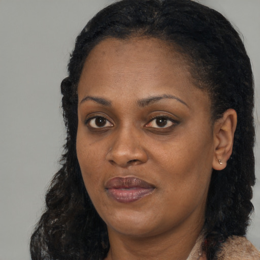 Joyful black adult female with medium  black hair and brown eyes