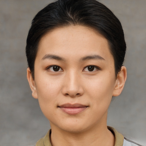 Joyful asian young-adult female with short  brown hair and brown eyes