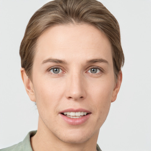 Joyful white young-adult female with short  brown hair and grey eyes