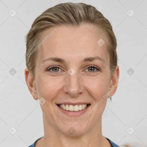 Joyful white adult female with short  brown hair and grey eyes