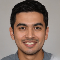 Joyful latino young-adult male with short  black hair and brown eyes