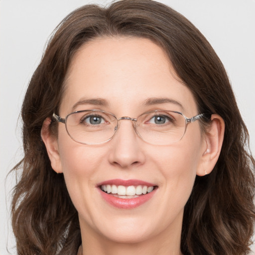 Joyful white adult female with medium  brown hair and grey eyes