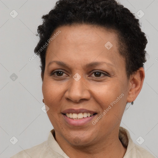 Joyful latino adult female with short  brown hair and brown eyes