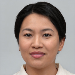 Joyful asian young-adult female with short  black hair and brown eyes