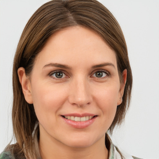 Joyful white young-adult female with medium  brown hair and grey eyes