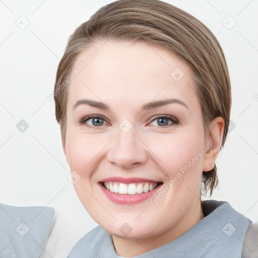 Joyful white young-adult female with medium  brown hair and grey eyes