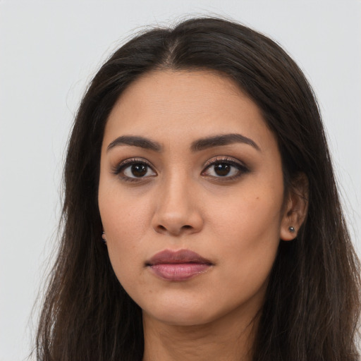 Neutral latino young-adult female with long  brown hair and brown eyes