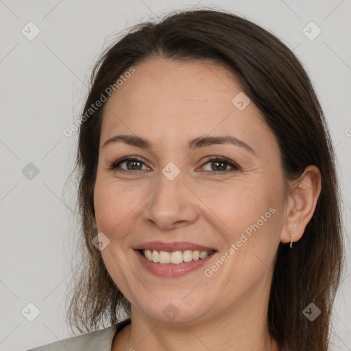 Joyful white adult female with medium  brown hair and brown eyes