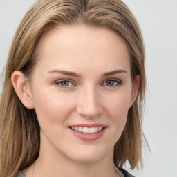 Joyful white young-adult female with long  brown hair and blue eyes