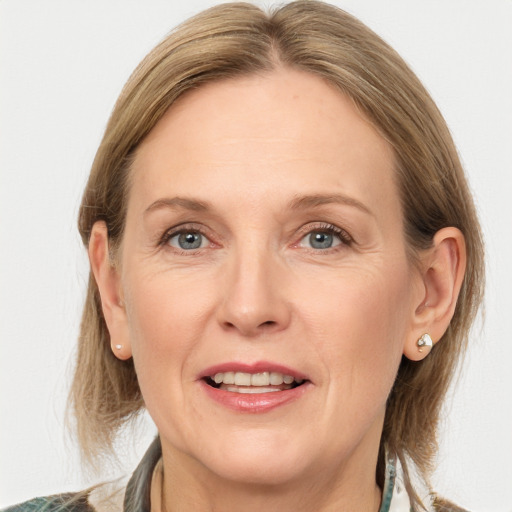 Joyful white adult female with medium  brown hair and grey eyes