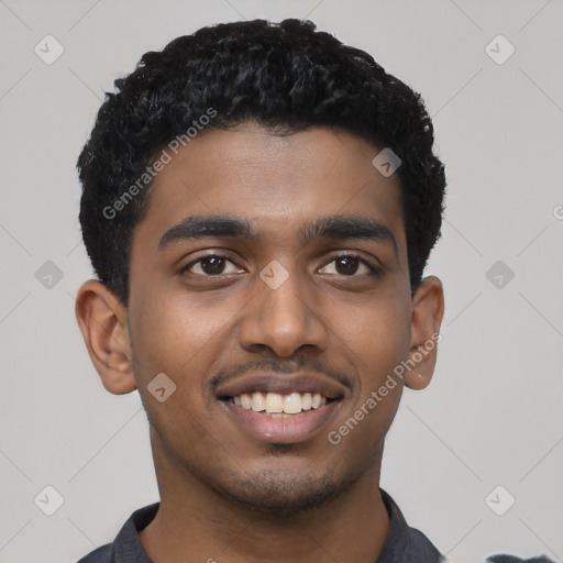 Joyful black young-adult male with short  black hair and brown eyes