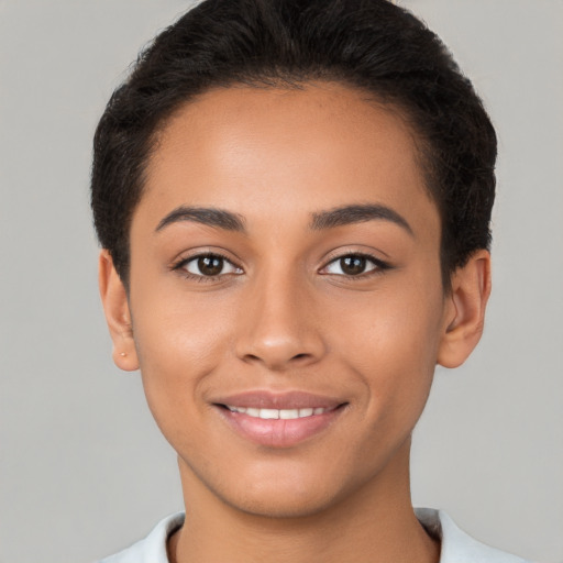 Joyful latino young-adult female with short  brown hair and brown eyes