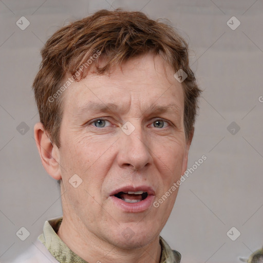 Joyful white adult male with short  brown hair and grey eyes