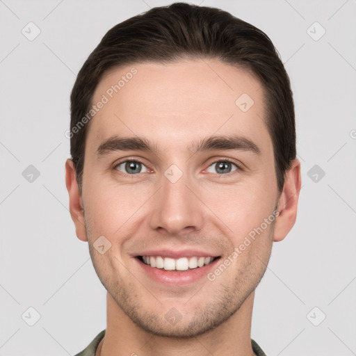 Joyful white young-adult male with short  brown hair and grey eyes