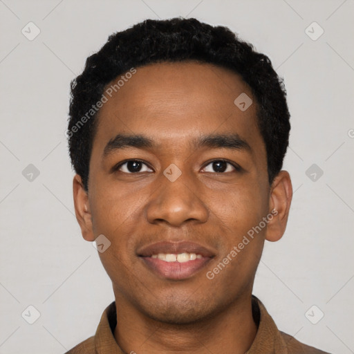 Joyful black young-adult male with short  black hair and brown eyes