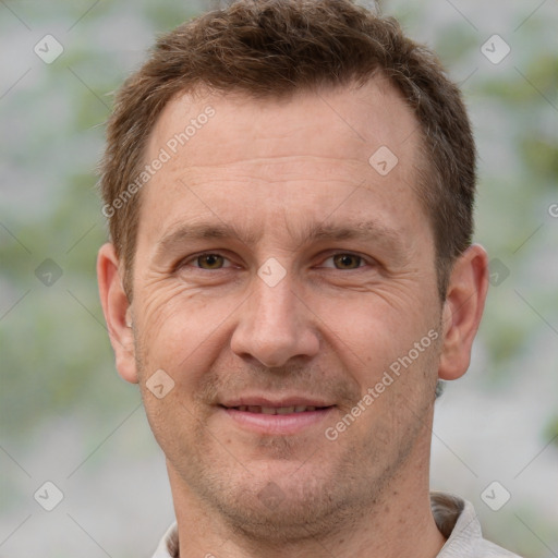 Joyful white adult male with short  brown hair and grey eyes