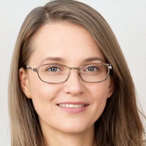 Joyful white adult female with long  brown hair and grey eyes