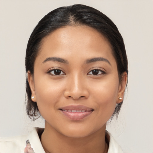 Joyful latino young-adult female with medium  black hair and brown eyes