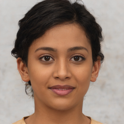 Joyful latino young-adult female with short  brown hair and brown eyes