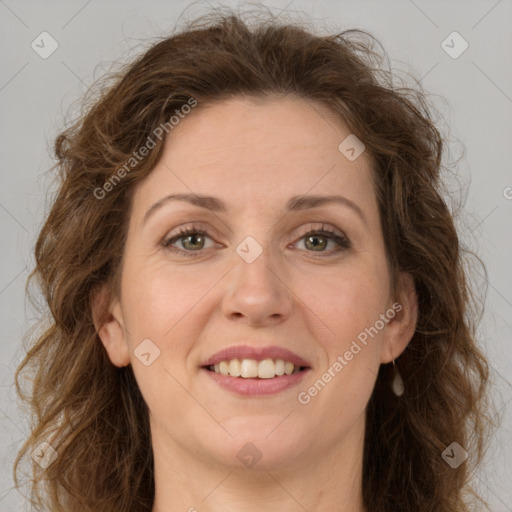 Joyful white adult female with long  brown hair and brown eyes