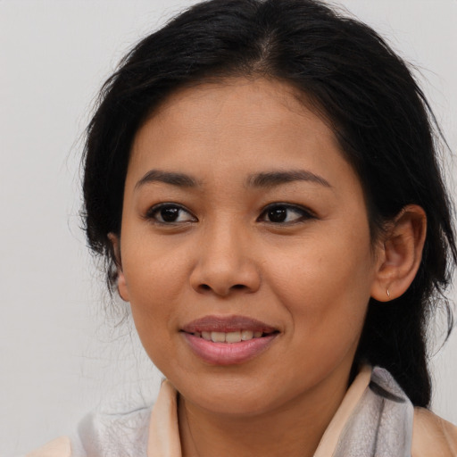 Joyful asian young-adult female with long  brown hair and brown eyes