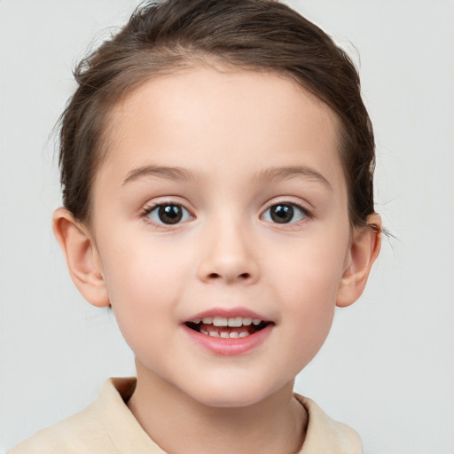 Joyful white child female with short  brown hair and brown eyes