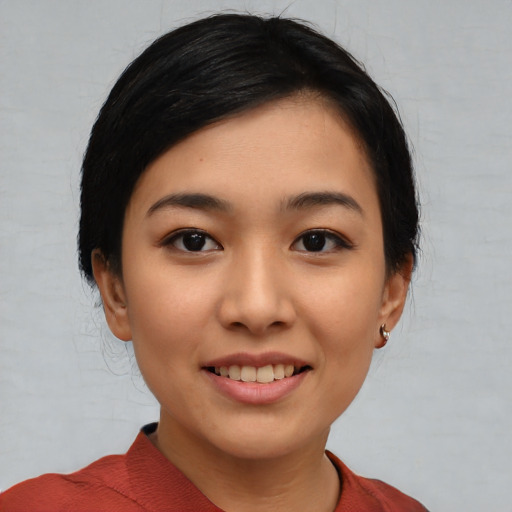 Joyful asian young-adult female with short  black hair and brown eyes