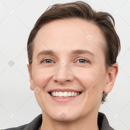 Joyful white adult male with short  brown hair and grey eyes