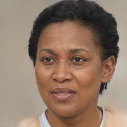 Joyful black adult female with short  brown hair and brown eyes