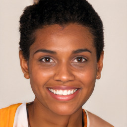Joyful black young-adult female with short  brown hair and brown eyes