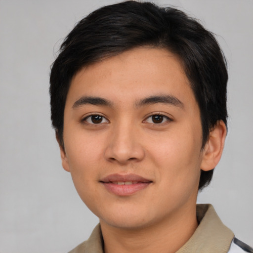 Joyful asian young-adult male with short  black hair and brown eyes