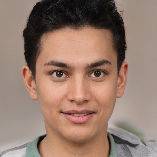 Joyful latino young-adult male with short  brown hair and brown eyes