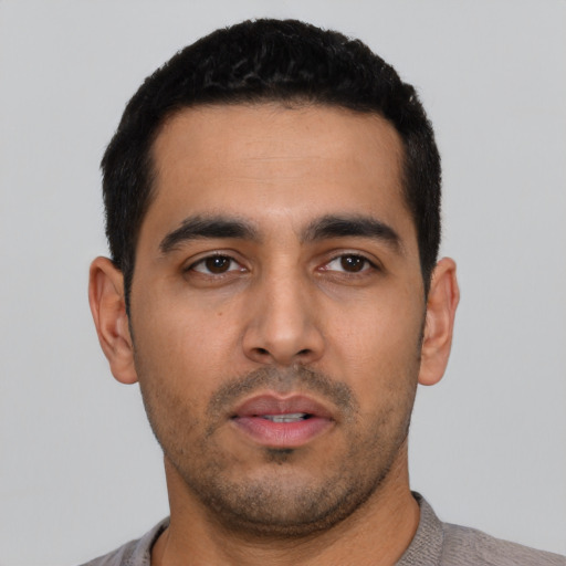 Neutral latino young-adult male with short  black hair and brown eyes