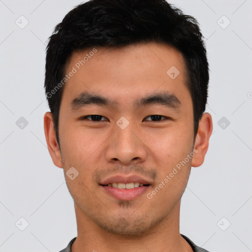 Joyful asian young-adult male with short  black hair and brown eyes