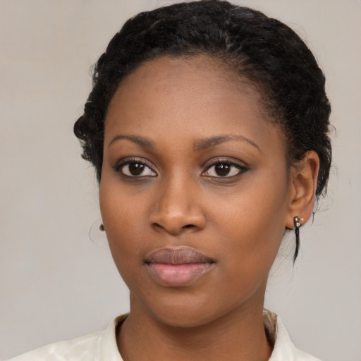 Neutral black young-adult female with medium  brown hair and brown eyes