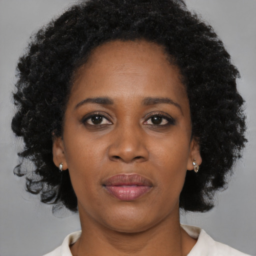 Joyful black young-adult female with medium  black hair and brown eyes