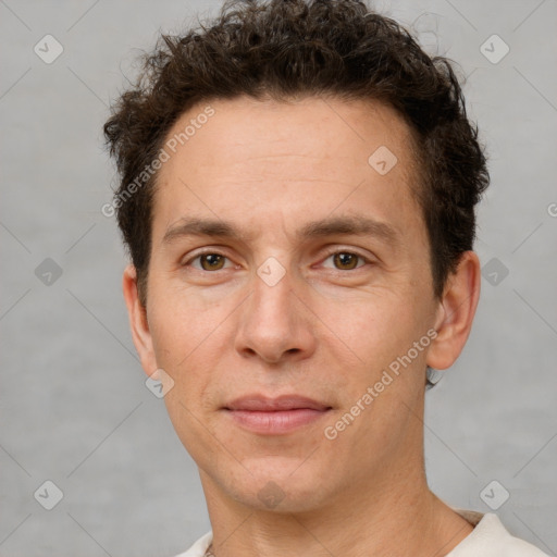 Joyful white adult male with short  brown hair and brown eyes