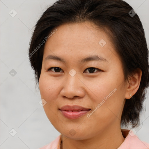 Joyful asian adult female with medium  brown hair and brown eyes