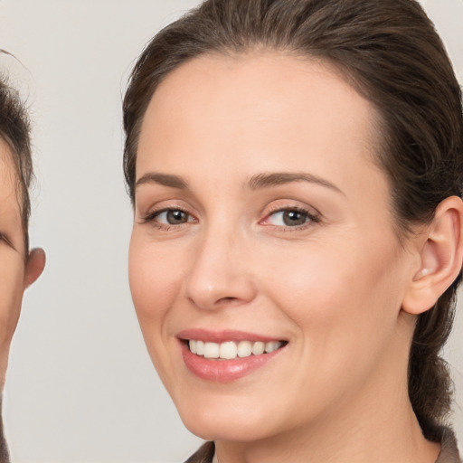 Joyful white young-adult female with medium  brown hair and brown eyes