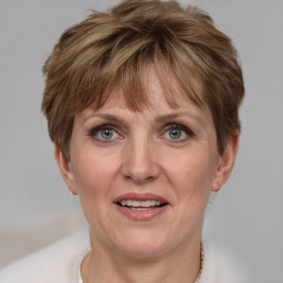 Joyful white adult female with short  brown hair and grey eyes