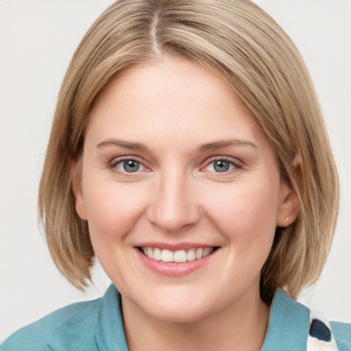 Joyful white young-adult female with medium  brown hair and blue eyes