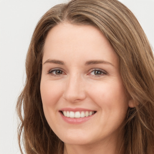 Joyful white young-adult female with long  brown hair and brown eyes