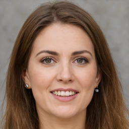 Joyful white young-adult female with long  brown hair and green eyes