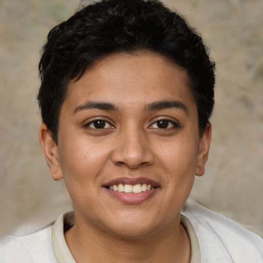 Joyful latino young-adult female with short  brown hair and brown eyes