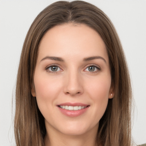 Joyful white young-adult female with long  brown hair and grey eyes