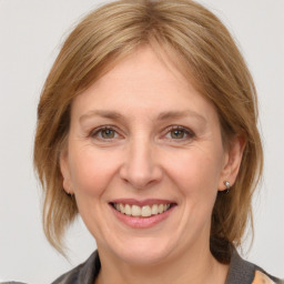 Joyful white adult female with medium  brown hair and grey eyes