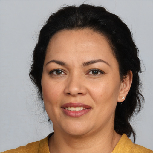 Joyful white adult female with medium  brown hair and brown eyes